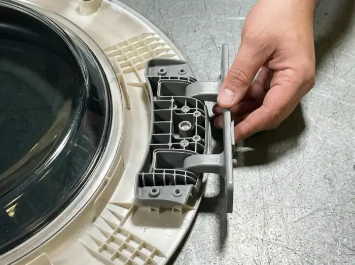 New OEM LG dryer door hinge installed — replacement repair