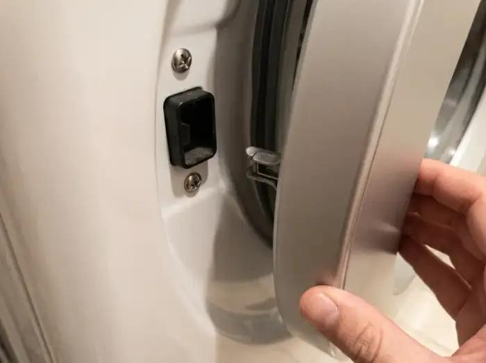 Worn LG dryer door latch assembly — damaged mechanism causing door failure