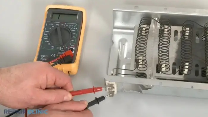 Technician testing LG dryer heating element continuity with multimeter
